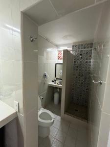a bathroom with a toilet and a shower and a sink at Casa Lo de Linda in Lo de Marcos +8 photos