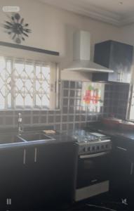 a kitchen with a sink and a stove top oven at Four bedrooms house in Kumasi