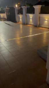 an empty parking lot at night with lights at Four bedrooms house in Kumasi