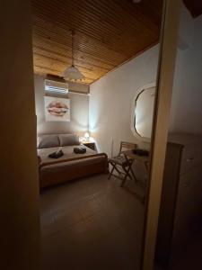 a bedroom with a bed and a table and a chair at Male home in Maletiánoi