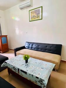 a living room with a couch and a table at Charming apartment in M'bour + 100 m² + pool in Mbour +9 photos