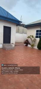 a house with a brick patio in front of it at Four bedrooms house in Kumasi