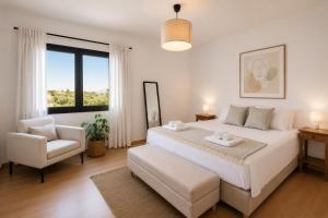 a bedroom with a bed and a chair and a window at Gregorys Private Luxury Villa with Heated Pool & Gardens in SFakianalíon +33 photos