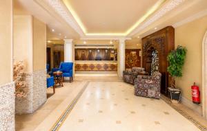 a lobby of a hotel with chairs and tables at St George Hotel - The Zoo in Cairo