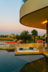 a swimming pool with a hot tub next to a building at Luxury Premium Villa Golf Resort Private Pool in Marrakesh