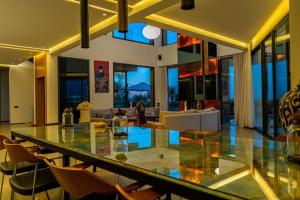 a dining room with a glass table and a living room at Luxury Premium Villa Golf Resort Private Pool in Marrakesh