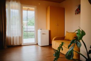 a living room with a couch and a refrigerator at Mountain View in Lagodekhi