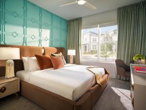 a hotel room with a large bed and a window at Villatel Orlando Resort in Orlando