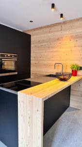 a kitchen with a wooden counter with a sink at Coriva Homes - Cogolo in Cogolo