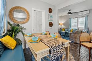 a living room with a table and a dining room at Coastal Escape, Steps to Beach, Fire Pit in Galveston