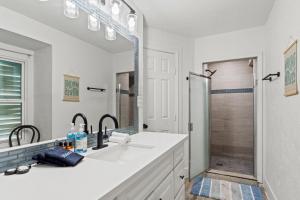 a white bathroom with a sink and a shower at Coastal Escape, Steps to Beach, Fire Pit in Galveston +80 photos