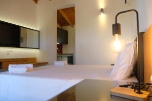 a living room with a table with a light on it at Aeon Retreat in Rovies