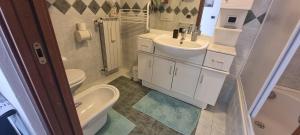 a bathroom with a sink and a toilet and a tub at Deby House in Oggebbio +26 photos