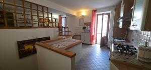 a kitchen with a counter and a stove top oven at Deby House in Oggebbio