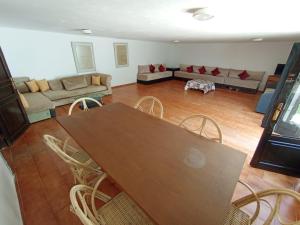 a living room with a table and chairs and a couch at Maison de plage familiale à Cabo in Cabo Negro