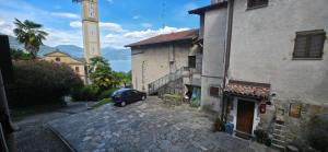 a car parked next to a building with a clock tower at Deby House in Oggebbio