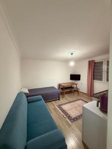a living room with a blue couch and a table at ÇAKIR's HOME OTEL in Çeşme