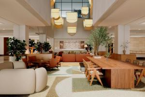 a large lobby with a large wooden table and chairs at Sheraton Rhodes Resort in Ixia