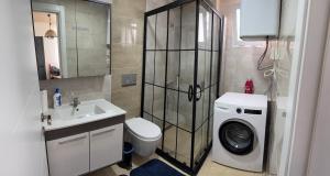 a bathroom with a washing machine and a washer at ÇAKIR's HOME OTEL in Çeşme +30 photos