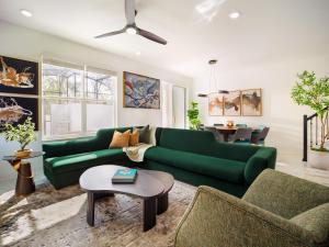 a living room with a green couch and a table at Villatel Orlando Resort in Orlando +24 photos