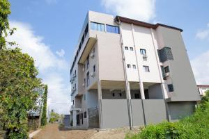 a white building with a fence in front of it at Angel's hôtel in Douala