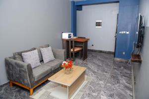 a living room with a couch and a table at Angel's hôtel in Douala