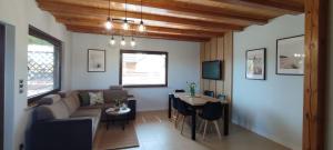 a living room with a couch and a table at Domki Malibu in Tupadła