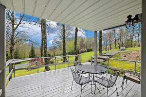 a patio with a table and chairs on a deck at Hiking Trails King Bed View Recently Renovated in Sugar Mountain