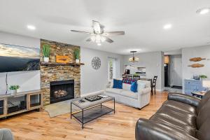 a living room with a couch and a fireplace at Hiking Trails King Bed View Recently Renovated in Sugar Mountain +27 photos