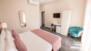 a hotel room with a bed and a desk at Brahma luxury B&B in Marigliano