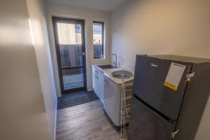 a small kitchen with a sink and a refrigerator at Stay at 2A in Twizel