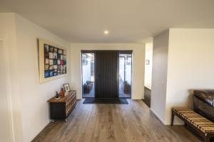 a living room with a couch and a door at Stay at 2A in Twizel +15 photos