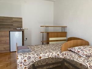 a bedroom with two beds and a wooden cabinet at Amelia Accommodation Pestani Ohrid in Ohrid