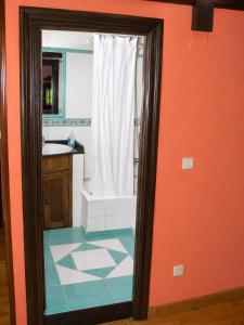 an orange bathroom with a shower and a sink at La Casina de Celorio in Celorio +14 photos