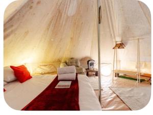 a bedroom with a large bed with an umbrella at Glamping Boutique in Comillas