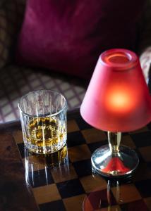 a glass of whiskey and a lamp on a chessboard at Earls Court House in Killarney +57 photos