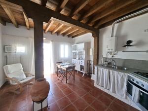 a kitchen with a counter and a table in it at Olhão Barreta typical home ASM in Olhão