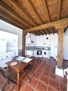 a kitchen and dining room with a wooden ceiling at Olhão Barreta typical home ASM in Olhão +22 photos