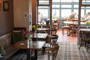 a restaurant with tables and chairs and people sitting at tables at The Sportsman in Amberley