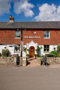 a red brick building with a sign that reads city subdivision at The Sportsman in Amberley