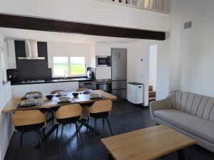 a kitchen and living room with a table and a couch at Sweet November in Valencia
