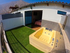 an outside deck of a house with a hot tub at Colpeña Chinchana in Chosica