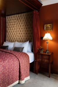 a bedroom with a bed and a table with a lamp at Earls Court House in Killarney