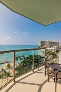 a balcony with a view of the beach and ocean at Waikiki Circle Hotel by Castle in Honolulu