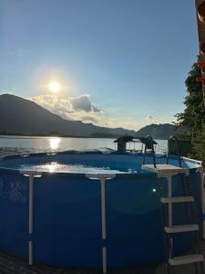 a swimming pool on the side of a body of water at Lure House in Mali Zvornik
