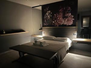 a bedroom with a bed and a table in it at Davis Kaizen in Brindisi