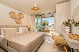 a bedroom with a large bed and a balcony at Villa Romas 3 by Villa Plus in Vasilikos +31 photos