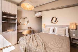 a bedroom with a large bed and a chair at Villa Romas 2 by Villa Plus in Vasilikos +14 photos