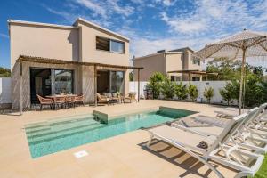 a villa with a swimming pool and a house at Villa Romas 2 by Villa Plus in Vasilikos