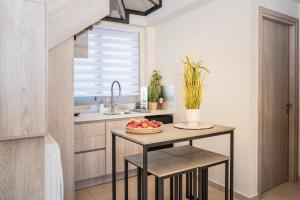 a kitchen with a table with a bowl of fruit on it at Villa Romas 2 by Villa Plus in Vasilikos
